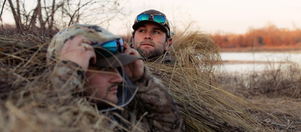 hunters waiting patiently in brush